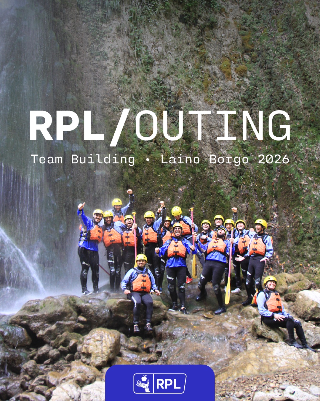 the team at the waterfall in rafting gear